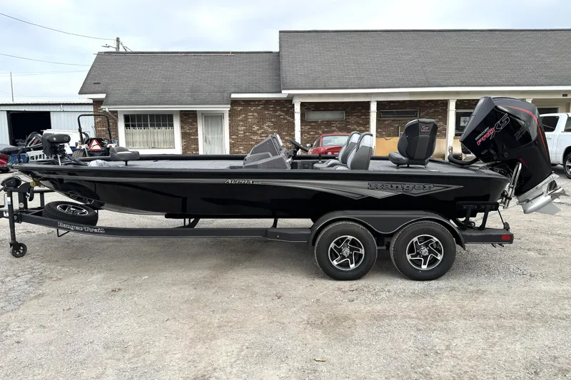 Slide: The Image of 2025 Ranger ALPHA 208 boat on trailer, parked outside a building. - 18