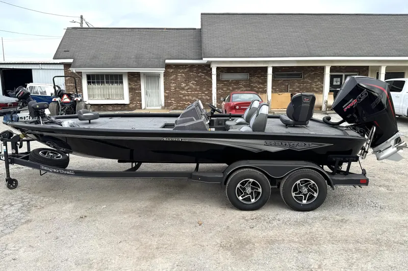 Slide: The Image of 2025 Ranger ALPHA 208 boat on trailer, parked outside a building. - 19