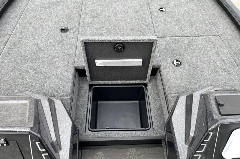 Slide: The Image of 2025 Ranger ALPHA 208 boat interior with open storage compartment, gray carpeted deck. - 21