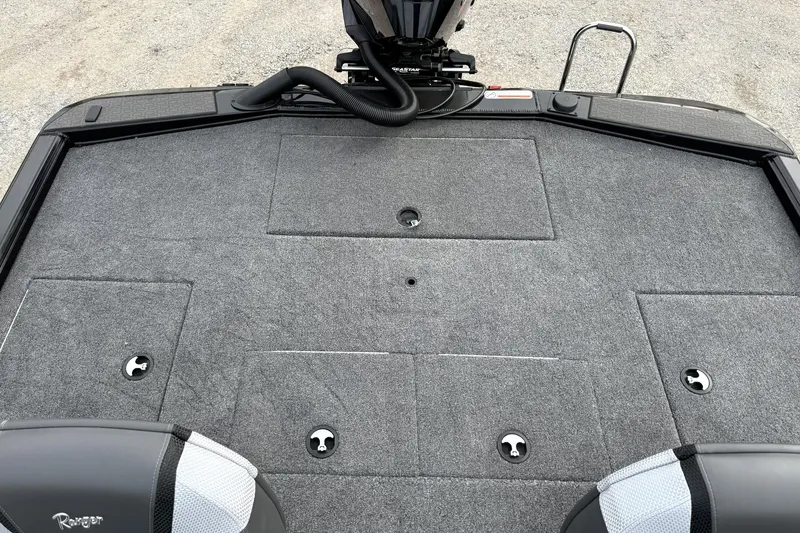 Slide: The Image of 2025 Ranger ALPHA 208 boat deck with gray carpet and storage compartments. - 26
