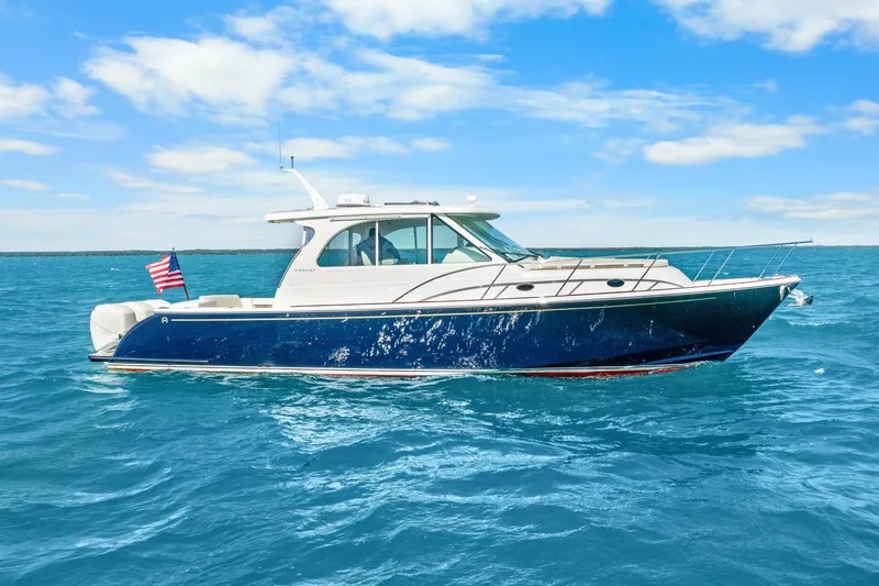 Slide: The Image of 2021 Hinckley Sport Boat 40 X cruising on blue ocean under clear sky. - 11