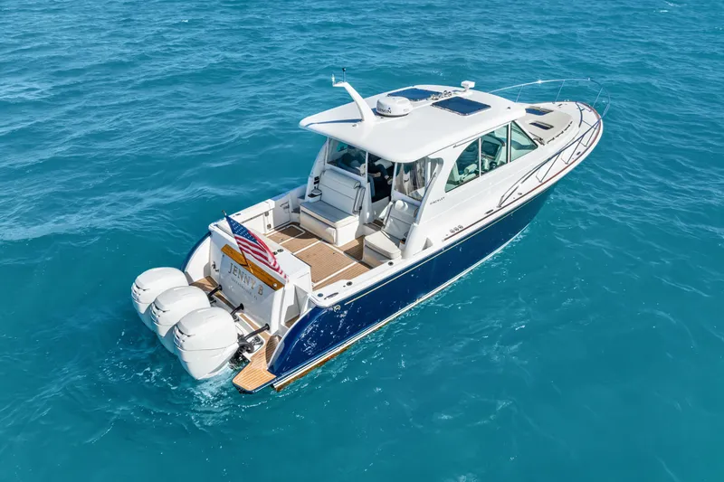 Slide: The Image of 2021 Hinckley Sport Boat 40 X cruising on clear blue water. - 12