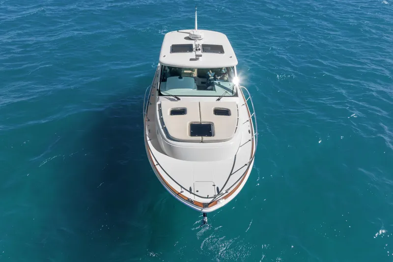 Slide: The Image of 2021 Hinckley Sport Boat 40 X cruising on clear blue water. - 14