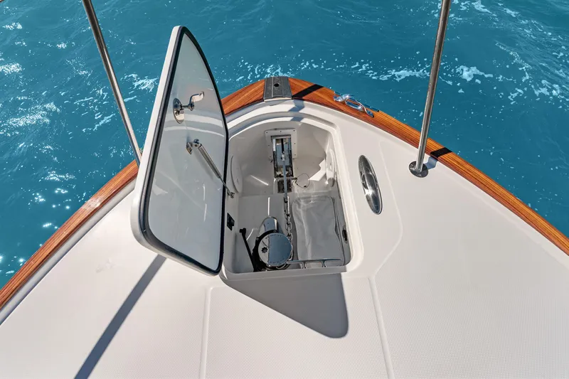 Slide: The Image of Hinckley Sport Boat 40 X 2021 anchor compartment open on blue ocean water. - 17