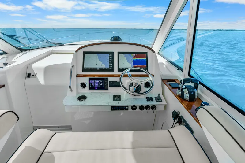 Slide: The Image of Helm of 2021 Hinckley Sport Boat 40 X with navigation screens and steering wheel. - 18