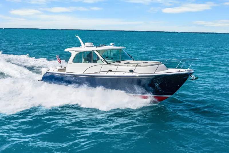 Slide: The Image of 2021 Hinckley Sport Boat 40 X cruising on blue ocean waters. - 2