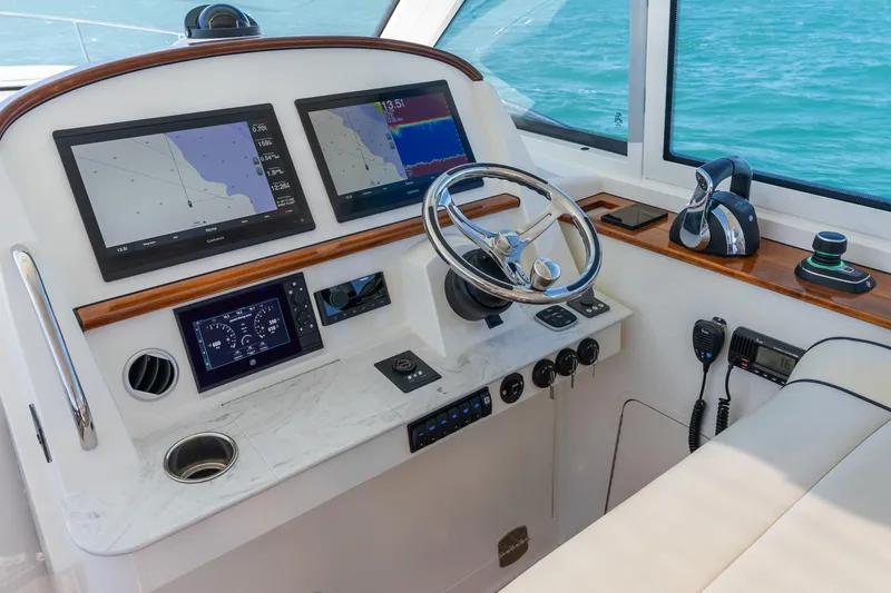 Slide: The Image of Helm of 2021 Hinckley Sport Boat 40 X with navigation screens and controls. - 20