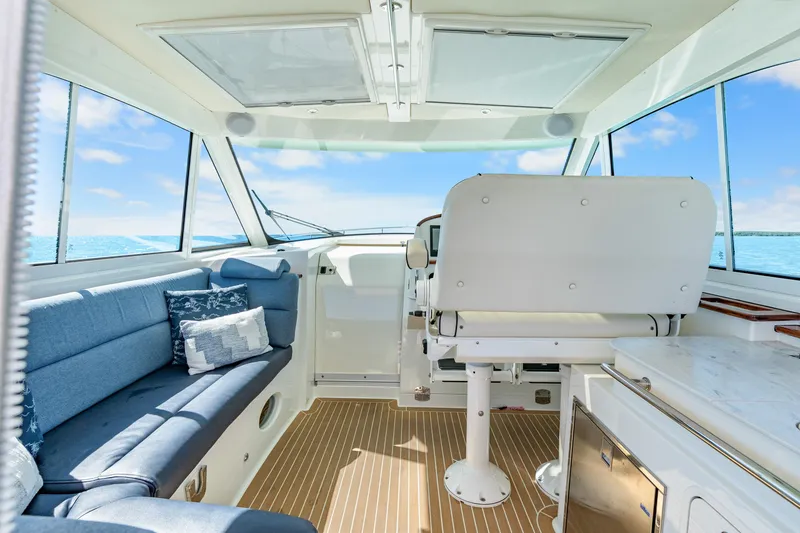 Slide: The Image of Interior of 2021 Hinckley Sport Boat 40 X with blue seating and ocean view. - 24