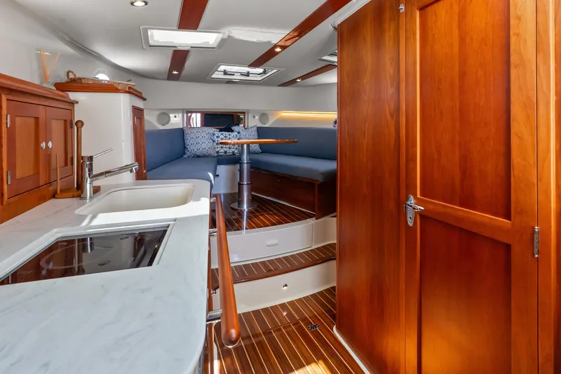 Slide: The Image of Interior of 2021 Hinckley Sport Boat 40 X with wood finishes and modern amenities. - 29