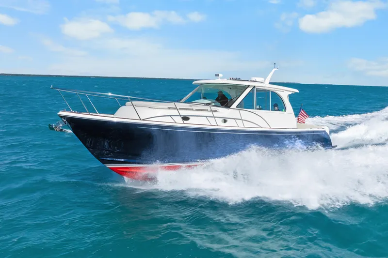 Slide: The Image of 2021 Hinckley Sport Boat 40 X cruising on blue ocean waters. - 3