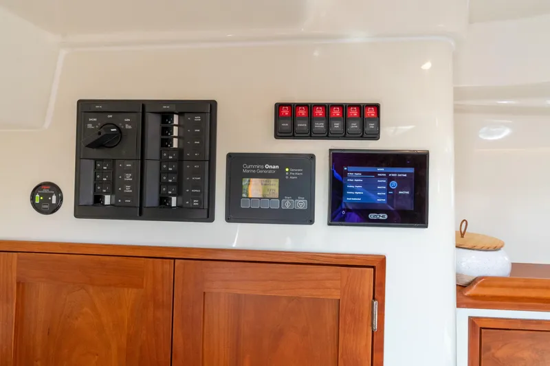 Slide: The Image of Control panel of 2021 Hinckley Sport Boat 40 X with generator and display screen. - 34