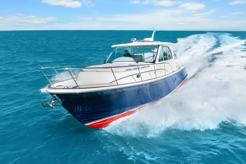Slide: The Image of 2021 Hinckley Sport Boat 40 X cruising on open blue water. - 4
