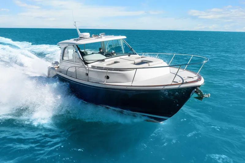 Slide: The Image of 2021 Hinckley Sport Boat 40 X cruising on clear blue ocean waters. - 5
