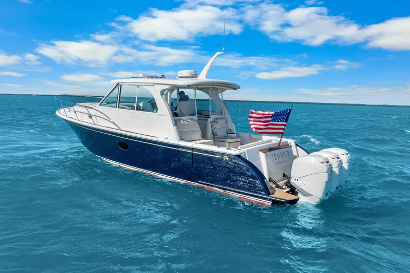 Slide: The Image of 2021 Hinckley Sport Boat 40 X cruising on blue ocean with American flag. - 9