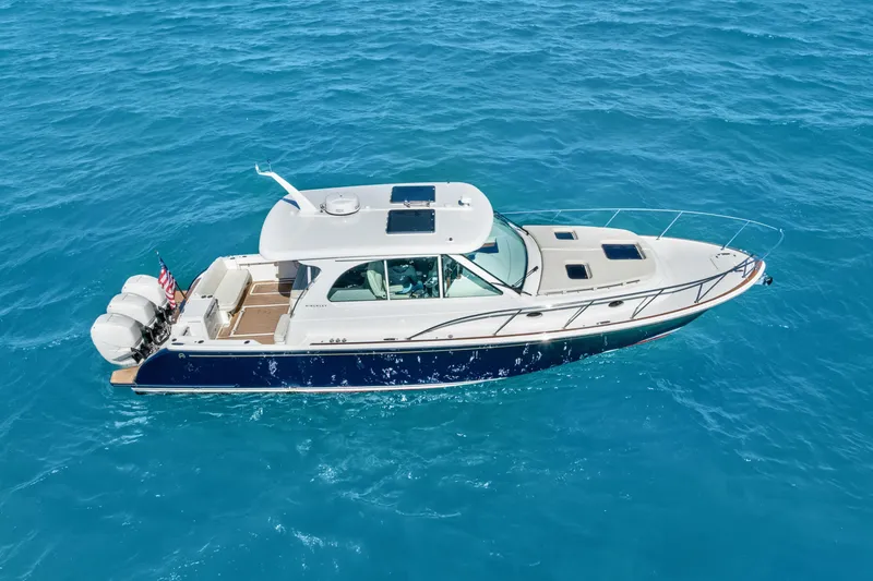 Slide: The Image of 2021 Hinckley Sport Boat 40 X cruising on clear blue water. - 13
