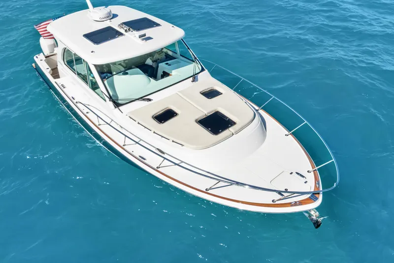 Slide: The Image of 2021 Hinckley Sport Boat 40 X cruising on clear blue water. - 15