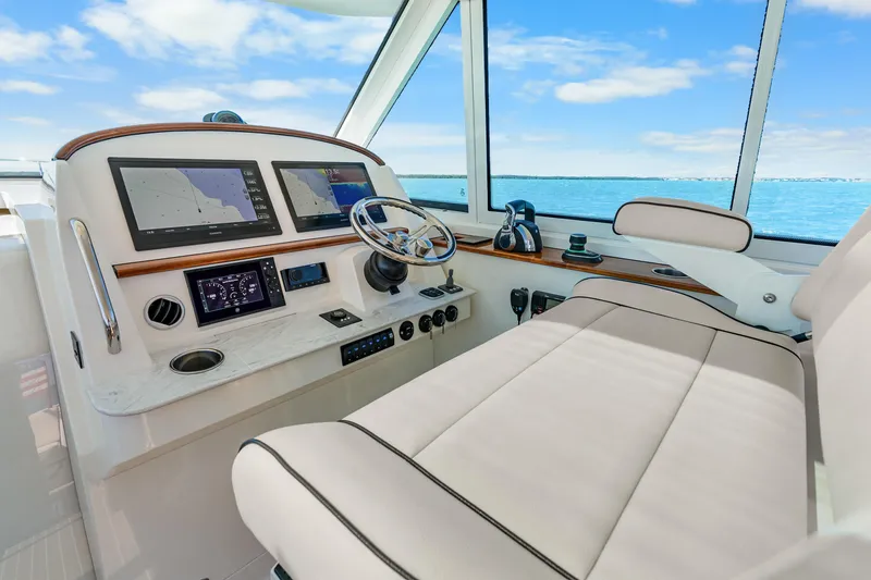 Slide: The Image of Helm of 2021 Hinckley Sport Boat 40 X with navigation screens and steering wheel. - 19