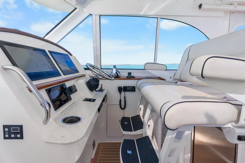 Slide: The Image of Interior of 2021 Hinckley Sport Boat 40 X, featuring modern helm and seating. - 21
