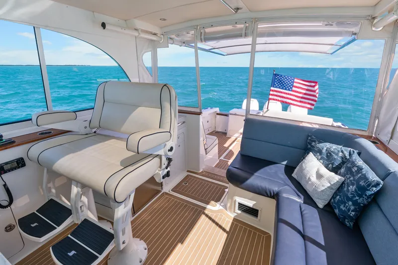 Slide: The Image of Luxurious 2021 Hinckley Sport Boat 40 X interior with seating, ocean view, and American flag. - 23
