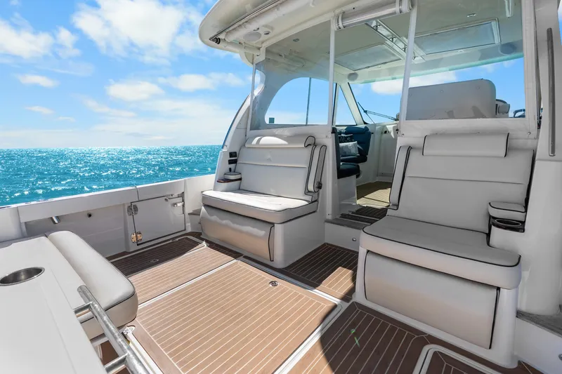 Slide: The Image of 2021 Hinckley Sport Boat 40 X interior with luxurious seating, ocean view, and sunny skies. - 26