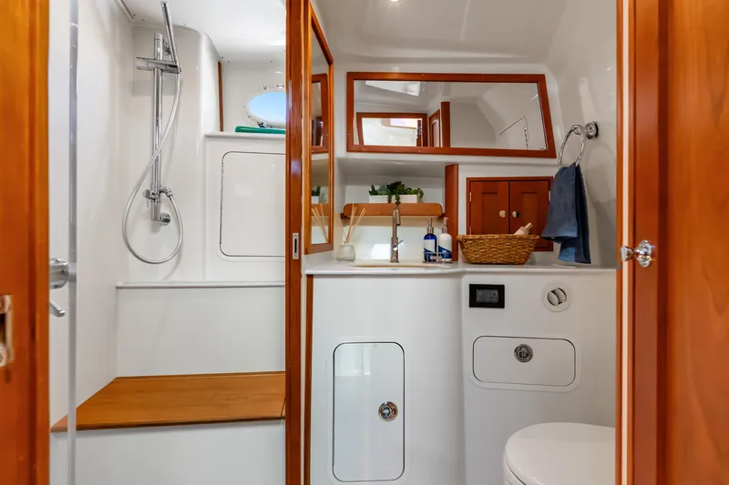 Slide: The Image of Luxurious bathroom interior of 2021 Hinckley Sport Boat 40 X with wooden accents. - 32