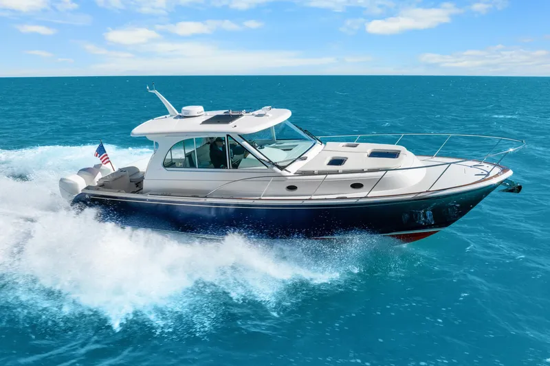 Slide: The Image of 2021 Hinckley Sport Boat 40 X cruising on clear blue ocean waters. - 6