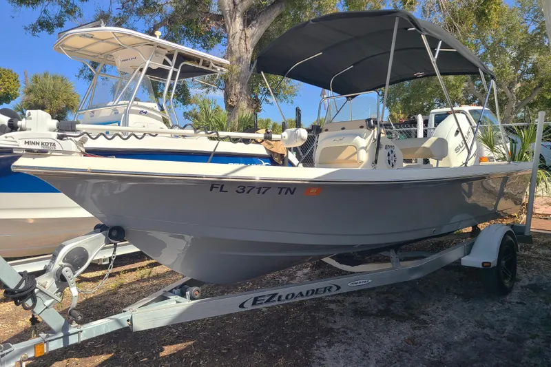 The Image of 2023 Bulls Bay 2000 boat on trailer, featuring canopy and outboard motor. - 0