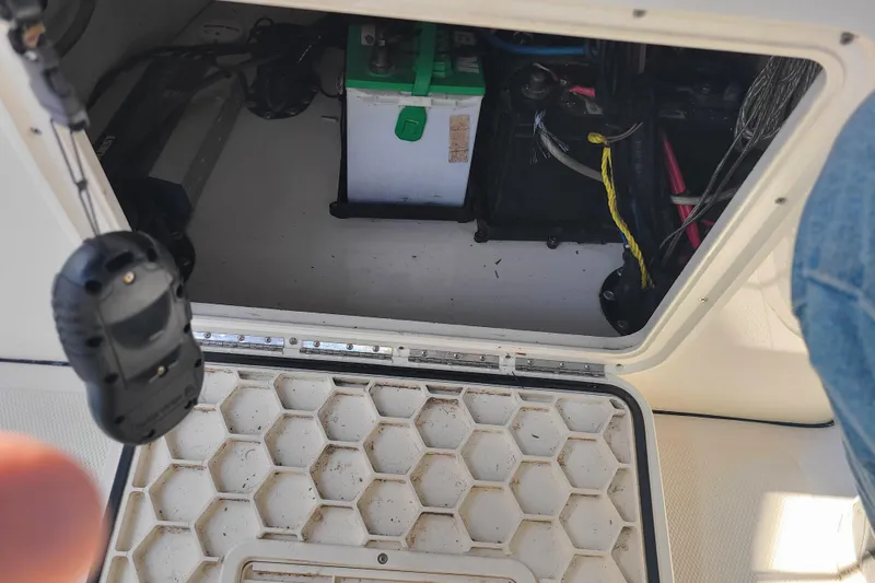 Slide: The Image of Open hatch of 2023 Bulls Bay 2000 boat showing battery and wiring. - 19