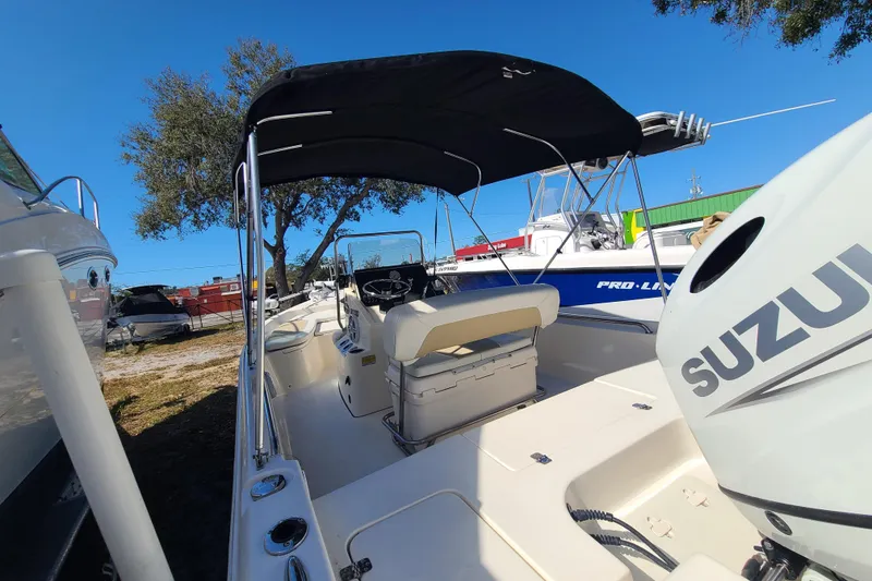 Slide: The Image of 2023 Bulls Bay 2000 boat with Suzuki engine, parked outdoors under clear blue sky. - 20