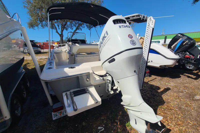 Slide: The Image of 2023 Bulls Bay 2000 boat with Suzuki 150 outboard motor, parked outdoors. - 24