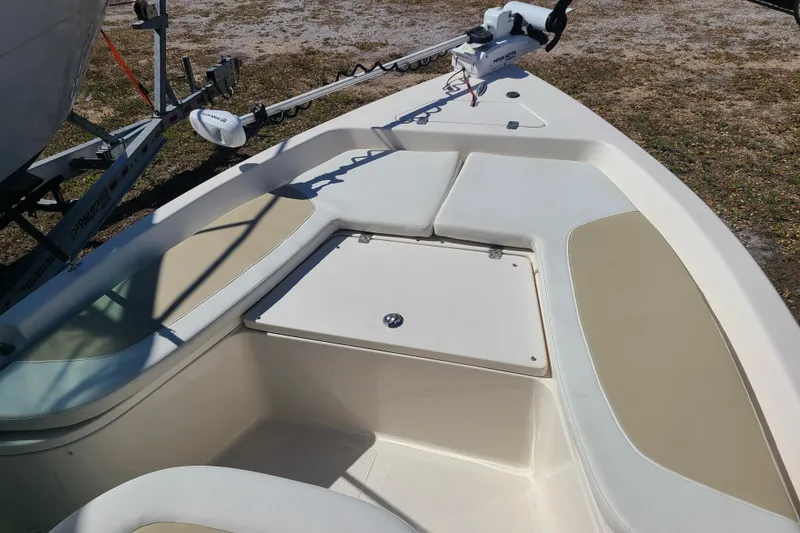 Slide: The Image of 2023 Bulls Bay 2000 boat interior with cushioned seating and storage compartment. - 6