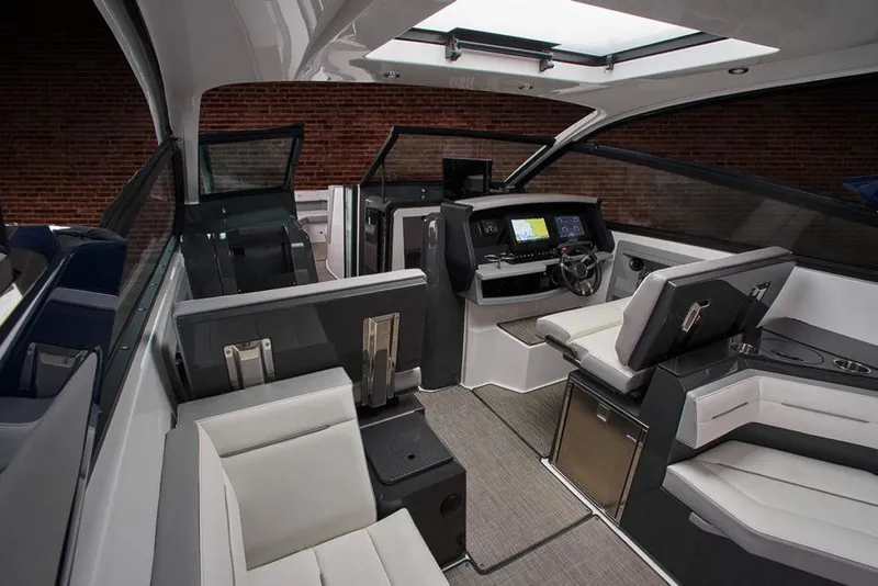 Slide: The Image of 2021 Cobalt A36BR boat interior with steering wheel and white seating. - 10