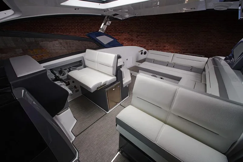 Slide: The Image of 2021 Cobalt A36BR boat dashboard with steering wheel, dual screens, and glasses. - 12