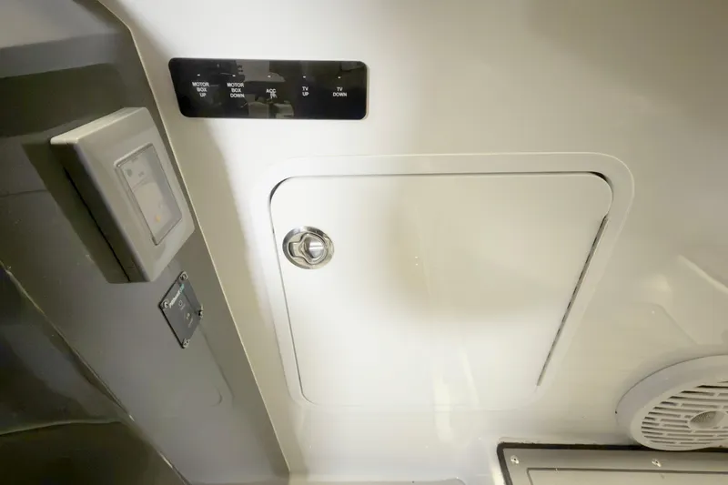 Slide: The Image of Control panel and storage compartment on 2021 Cobalt A36BR boat interior. - 18