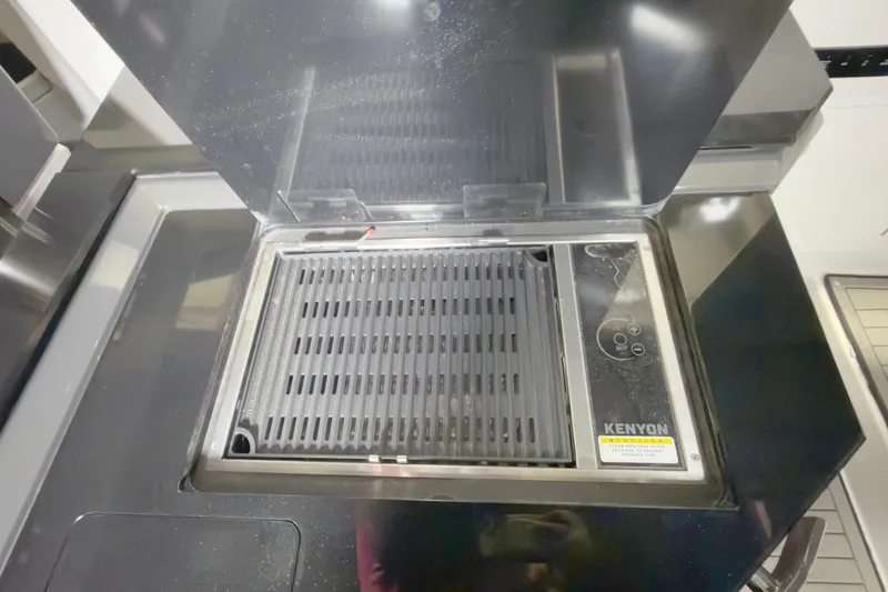 Slide: The Image of Built-in Kenyon grill on 2021 Cobalt A36BR boat, featuring sleek design and modern controls. - 21