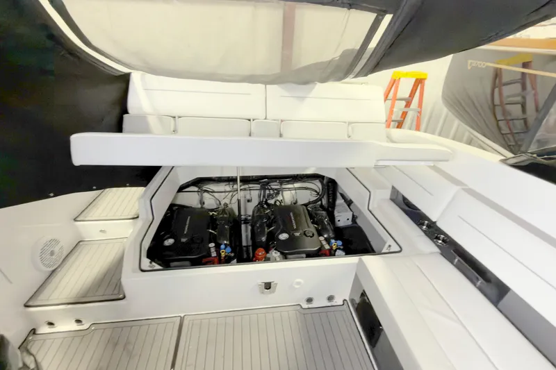 Slide: The Image of 2021 Cobalt A36BR boat engine compartment with open seating and visible twin engines. - 27