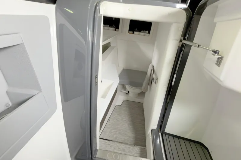 Slide: The Image of Interior of 2021 Cobalt A36BR boat, featuring a compact, modern bathroom space. - 32