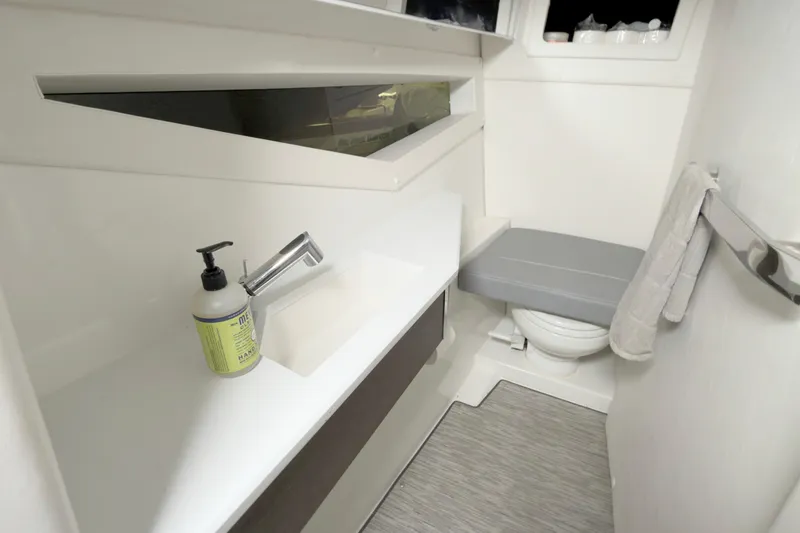 Slide: The Image of 2021 Cobalt A36BR boat bathroom with modern sink, toilet, and hand soap. - 34