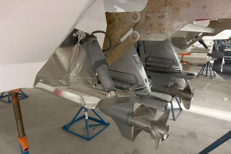 Slide: The Image of 2021 Cobalt A36BR boat propellers and trim tabs in a maintenance setting. - 39