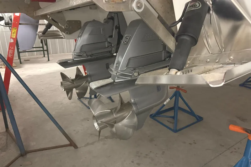 Slide: The Image of 2021 Cobalt A36BR boat with dual propellers on stands in a garage. - 40