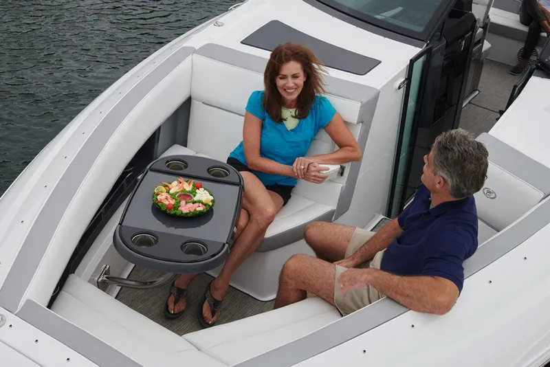 Slide: The Image of 2021 Cobalt A36BR boat cockpit with steering wheel and white seating. - 8