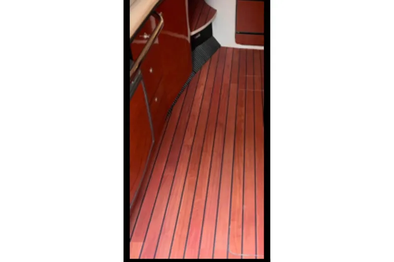 Slide: The Image of 2005 Sea Ray Sundancer 320 interior with polished wood flooring and cabinetry. - 7