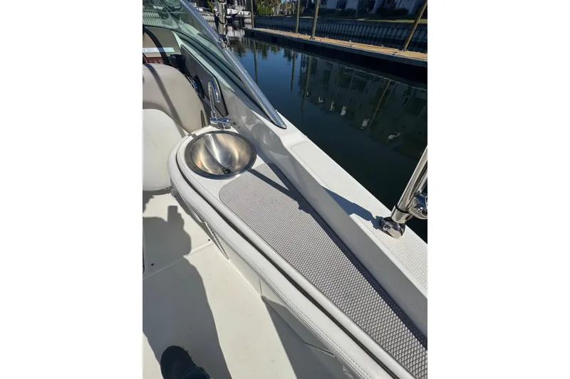 Slide: The Image of 2011 Sea Ray 260 Bow Rider interior with sink, docked by calm water. - 13