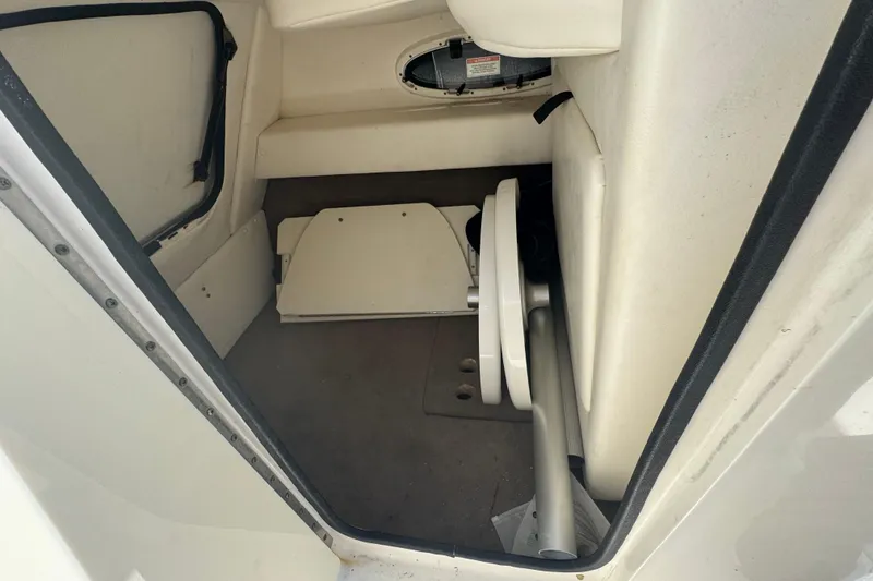 Slide: The Image of 2011 Sea Ray 260 Bow Rider interior storage compartment with hatch and equipment. - 14