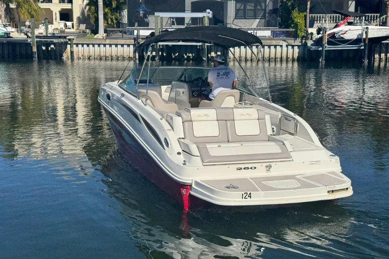 Slide: The Image of 2011 Sea Ray 260 Bow Rider boat on calm water near a dock. - 4