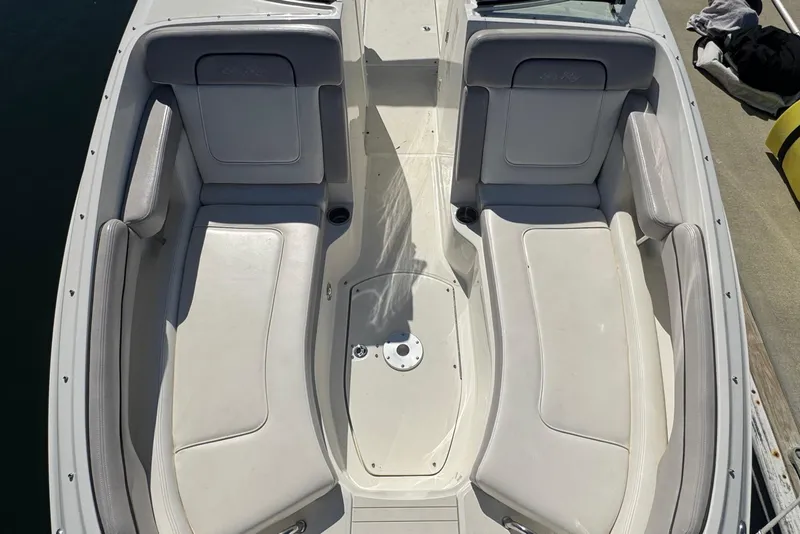 Slide: The Image of 2011 Sea Ray 260 Bow Rider boat interior with white seating and open deck. - 8