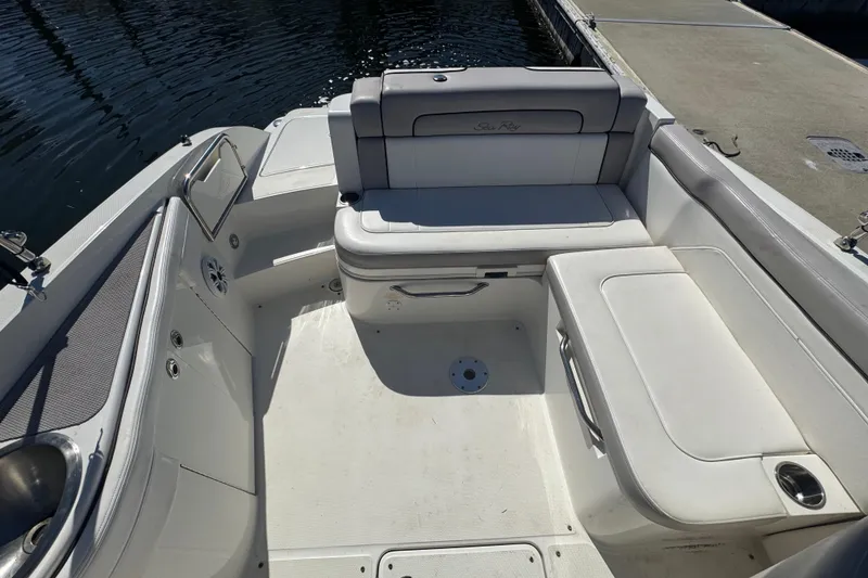 Slide: The Image of 2011 Sea Ray 260 Bow Rider interior with white seating and storage compartments. - 9