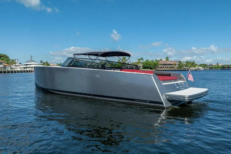 The Image of 2016 VanDutch 55 yacht on calm water, sleek design, sunny day, American flag displayed. - 0
