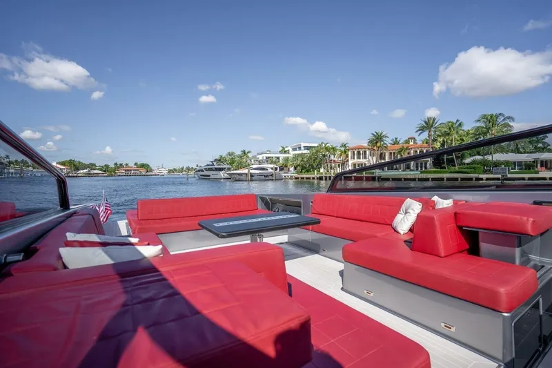 Slide: The Image of Luxurious 2016 VanDutch 55 yacht with red seating, cruising on a sunny waterfront. - 10