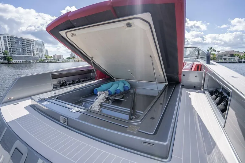 Slide: The Image of 2016 VanDutch 55 yacht with open storage compartment, docked by waterfront buildings. - 11